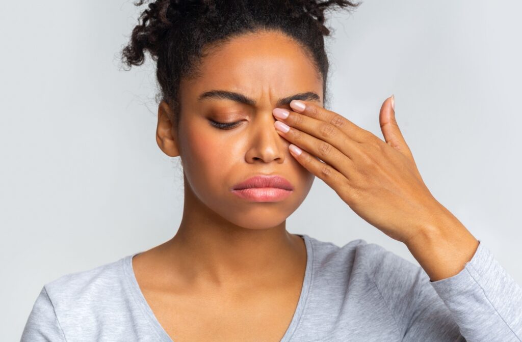 An adult rubs their dry, irritated eye and hopes they don't have a stye developing.