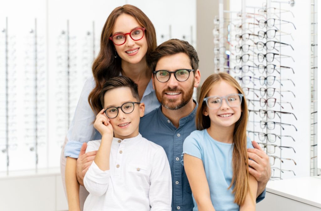 A young family of four all wearing glasses
